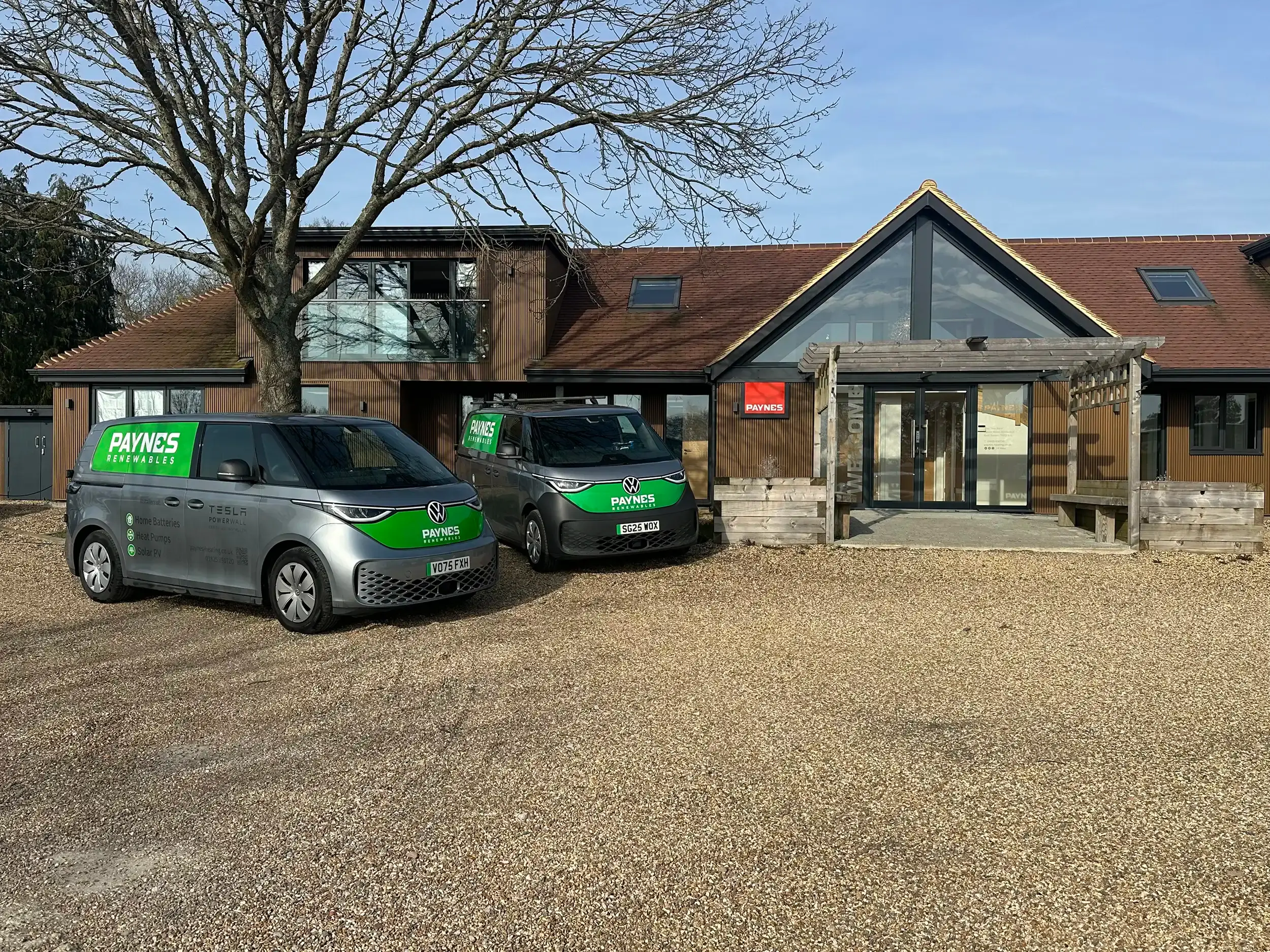A Paynes Renewables electric van parked outside the company's timber-clad office at Oak Tree Barn, Blackboys