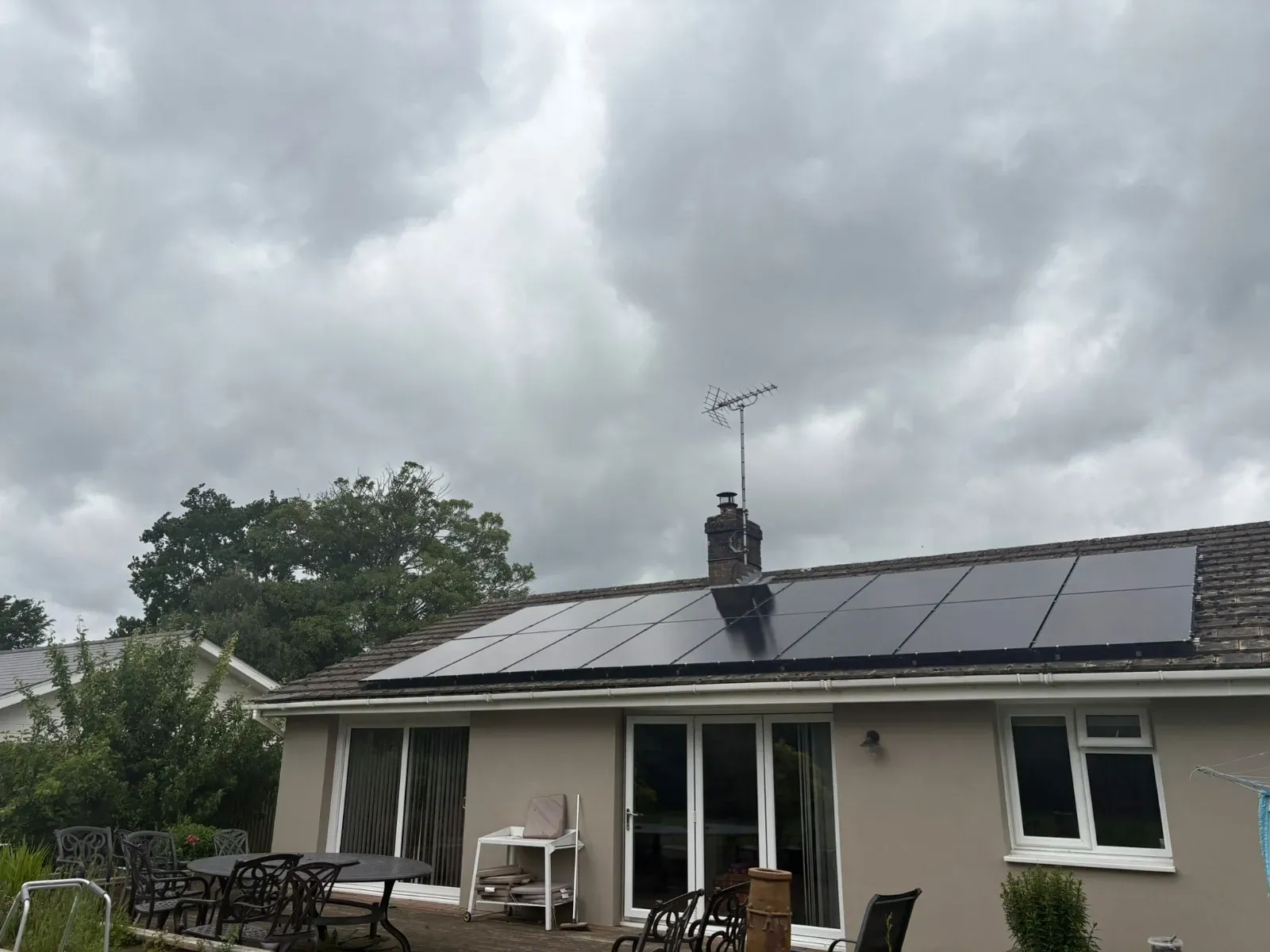 A bungalow with solar panels across its roof