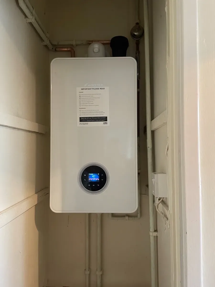 A compact boiler in a tiled alcove